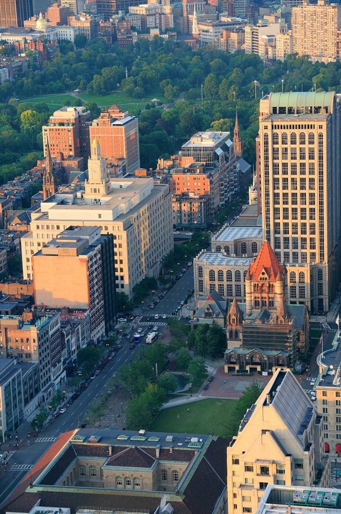 Boston city downtown aerial view with urban historical buildings at sunset.